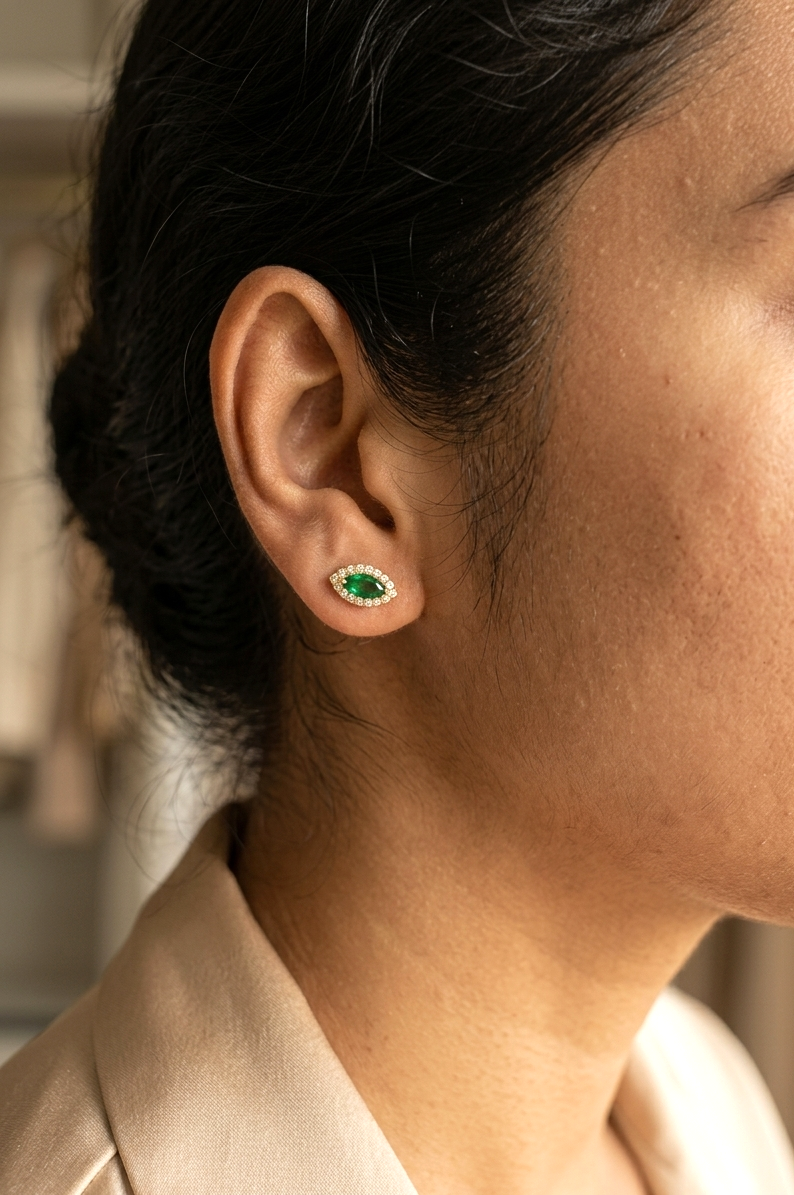Marquise emerald and diamond halo stud earrings in 18K yellow gold by Emirates Diamonds