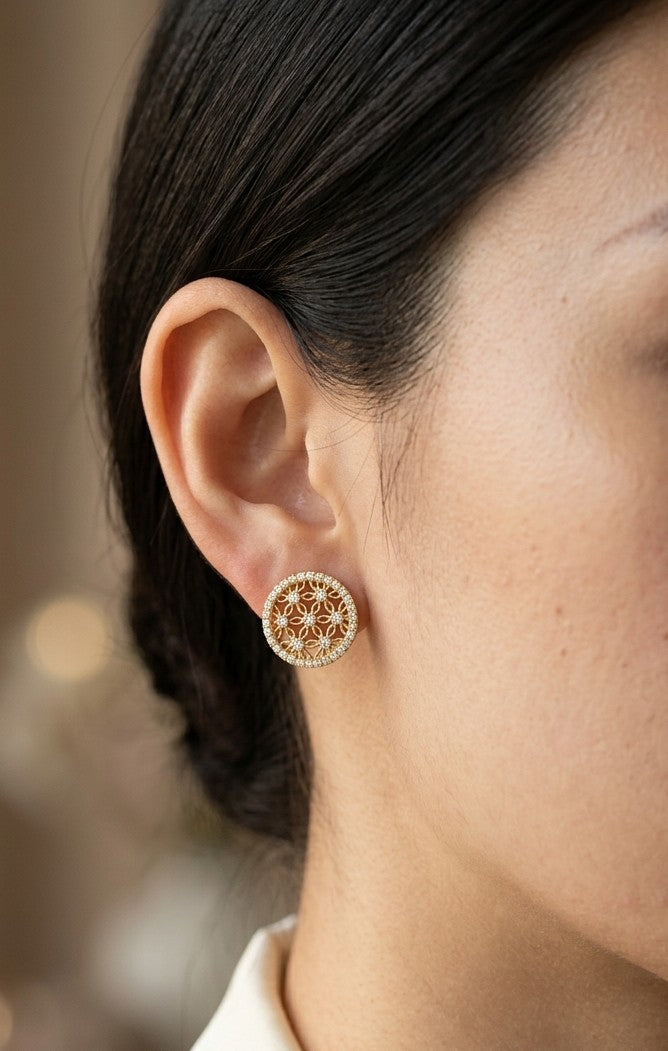 18K yellow gold diamond floral stud earrings with intricate openwork flower design and round brilliant diamond border
