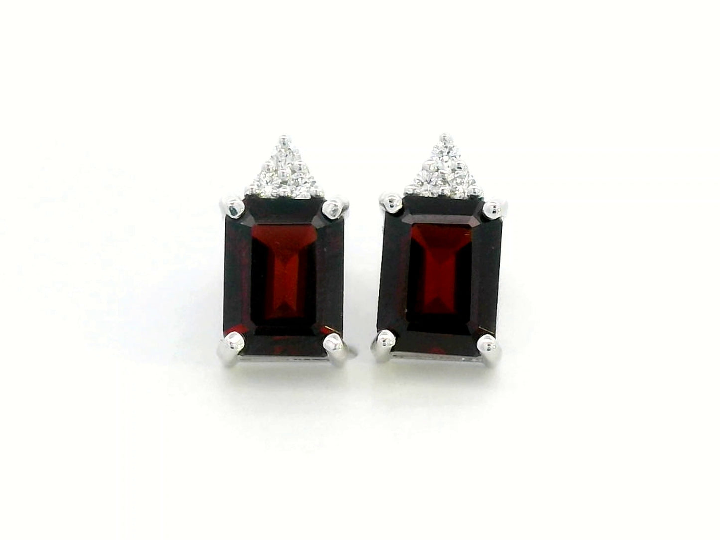 18K white gold garnet and diamond stud earrings featuring emerald-cut garnets (4.11 CT total) with a delicate diamond cluster (0.09 CT total), set in a classic and elegant stud design.