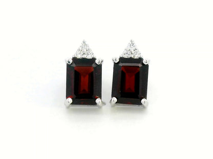 18K white gold garnet and diamond stud earrings featuring emerald-cut garnets (4.11 CT total) with a delicate diamond cluster (0.09 CT total), set in a classic and elegant stud design.