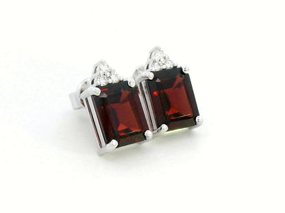 18K white gold garnet and diamond stud earrings featuring emerald-cut garnets (4.11 CT total) with a delicate diamond cluster (0.09 CT total), set in a classic and elegant stud design.