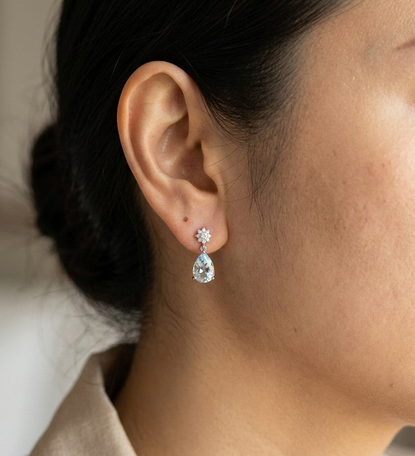 18K white gold aquamarine and diamond drop earrings with blue aquamarine gemstones and round diamond accents