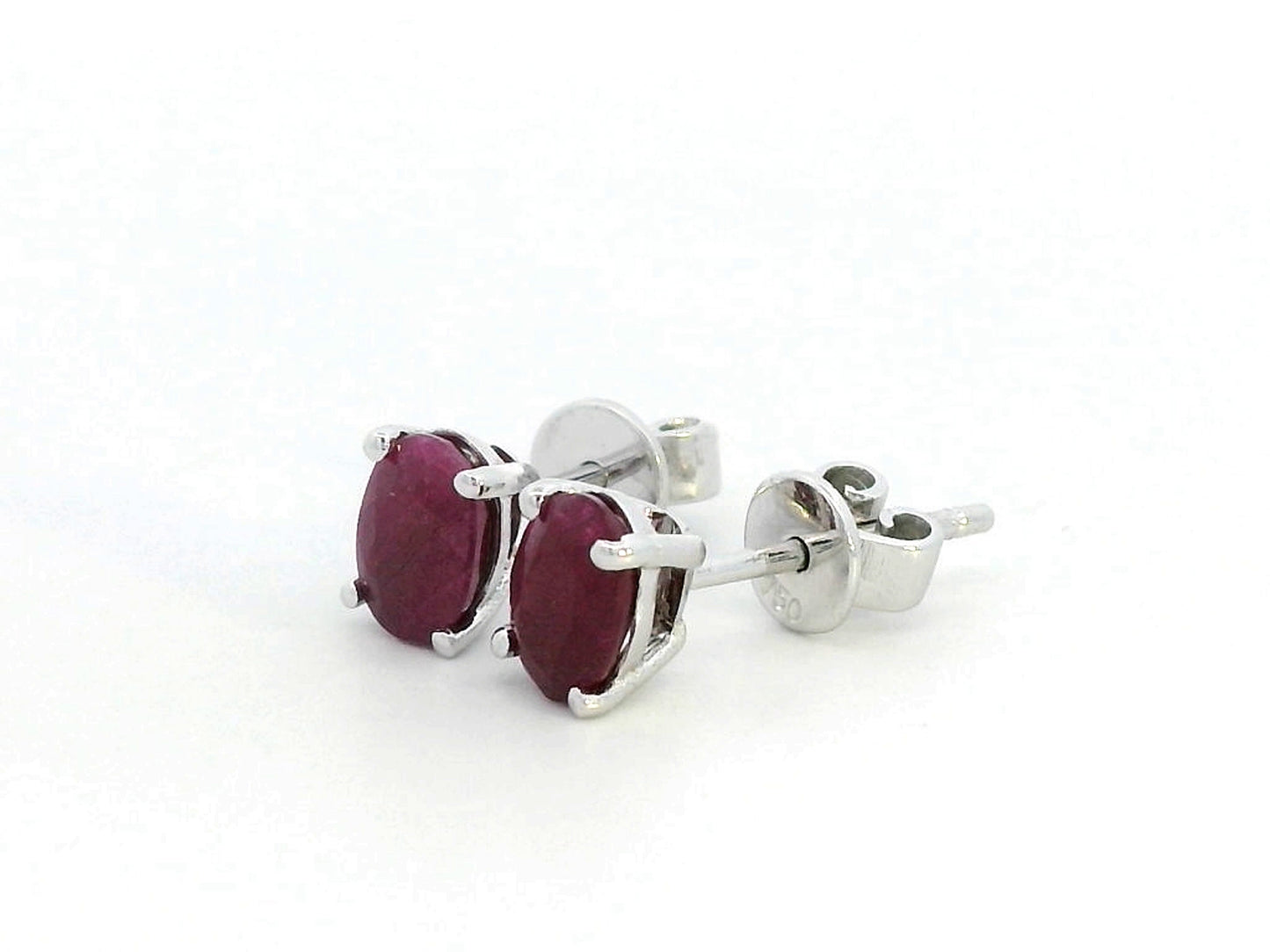 1.50 carat oval ruby stud earrings in 18K gold setting, July birthstone