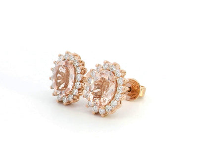 Diana-style 18K rose gold halo stud earrings featuring oval-cut morganites (2.77 carats) and round-cut diamonds (0.56 carats) in a regal, vintage-inspired design.