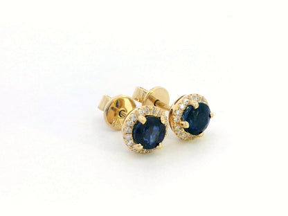 18K Gold Sapphire and Diamond Halo Stud Earrings featuring 1.48 carats of deep blue round-cut sapphires and 0.17 carats of brilliant diamonds,