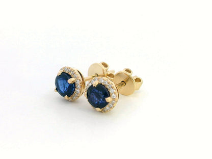 18K Gold Sapphire and Diamond Halo Stud Earrings featuring 1.48 carats of deep blue round-cut sapphires and 0.17 carats of brilliant diamonds,