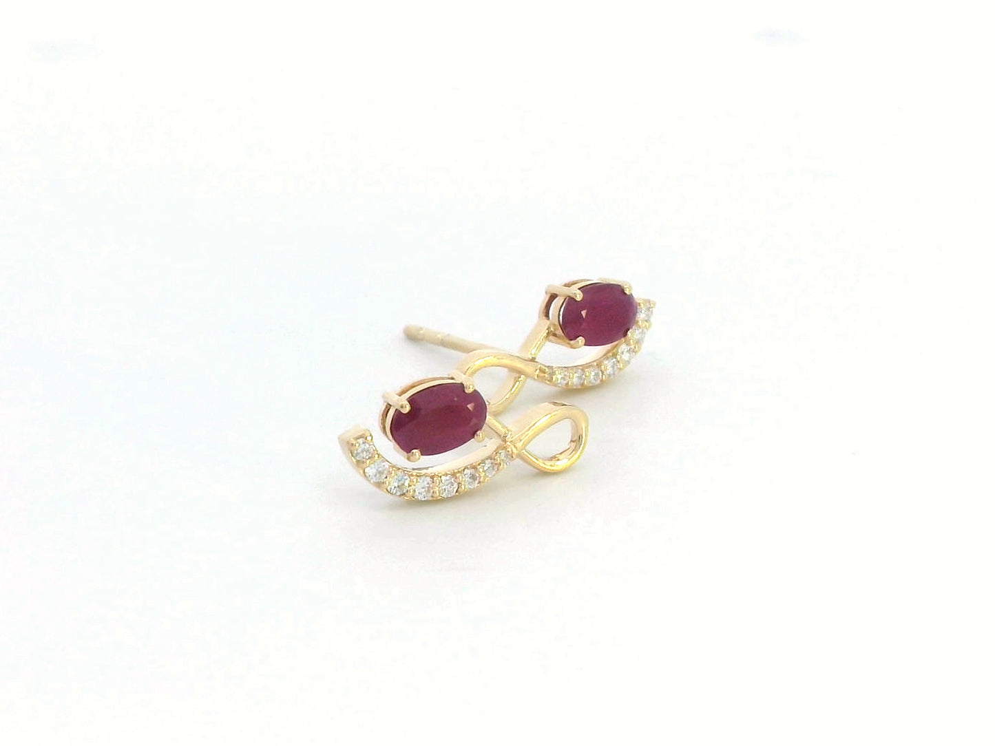 18K yellow gold infinity stud earrings featuring 1.02 carats of oval-cut rubies and 0.14 carats of diamonds.