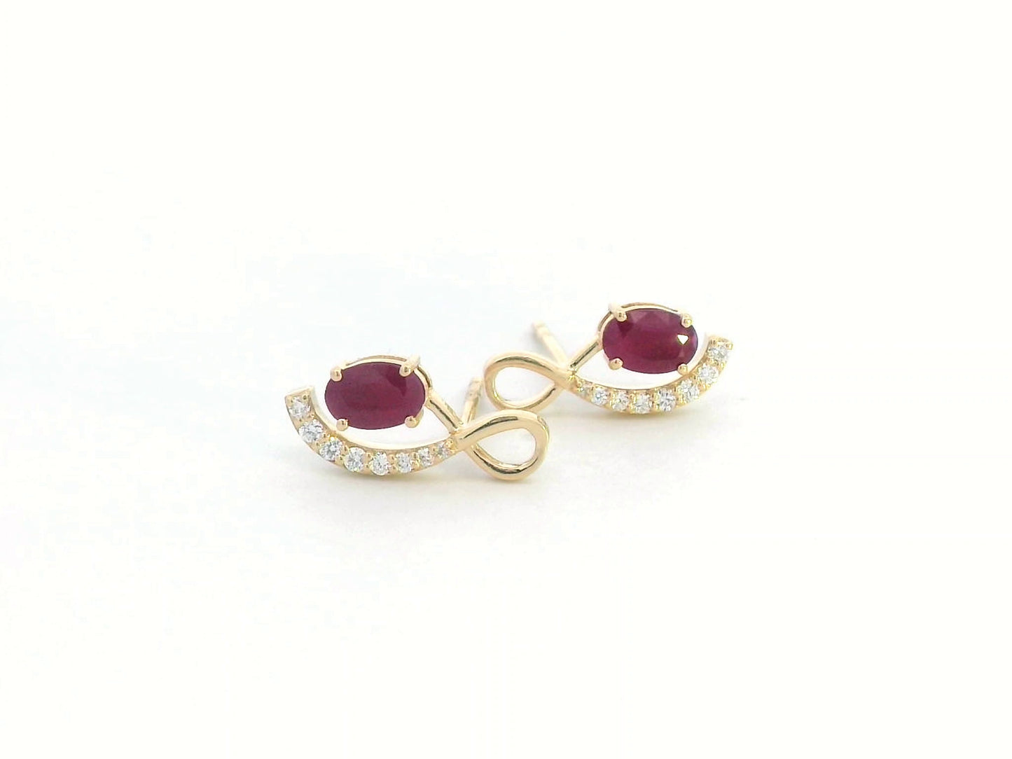 18K yellow gold infinity stud earrings featuring 1.02 carats of oval-cut rubies and 0.14 carats of diamonds.