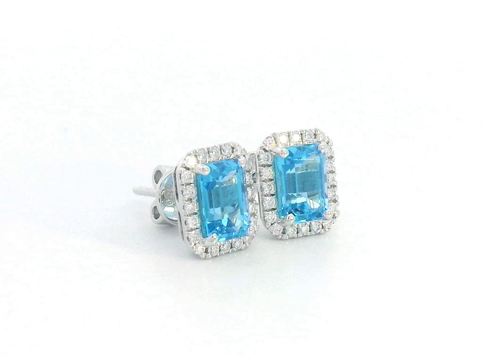 18K white gold blue topaz stud earrings with diamond halo, emerald-cut 2.18 CT gemstones, elegant gemstone earrings for women, December birthstone jewelry.