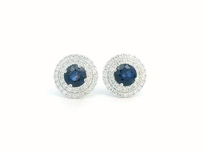 Round Sapphire and Diamond halo stud earrings in 18K white gold, featuring 2.27 carats of deep blue Sapphire and 0.81 carats of sparkling Diamonds.