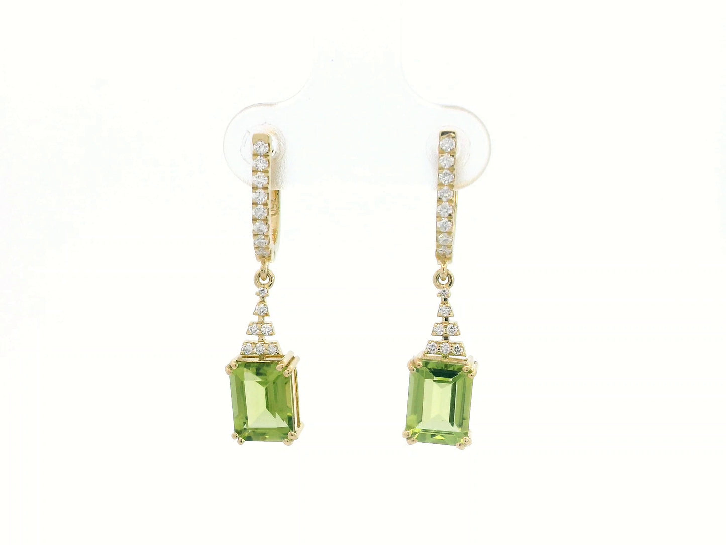 Emerald-cut Peridot and diamond drop earrings in 18K white gold, featuring vibrant green gemstones and brilliant diamond accents.