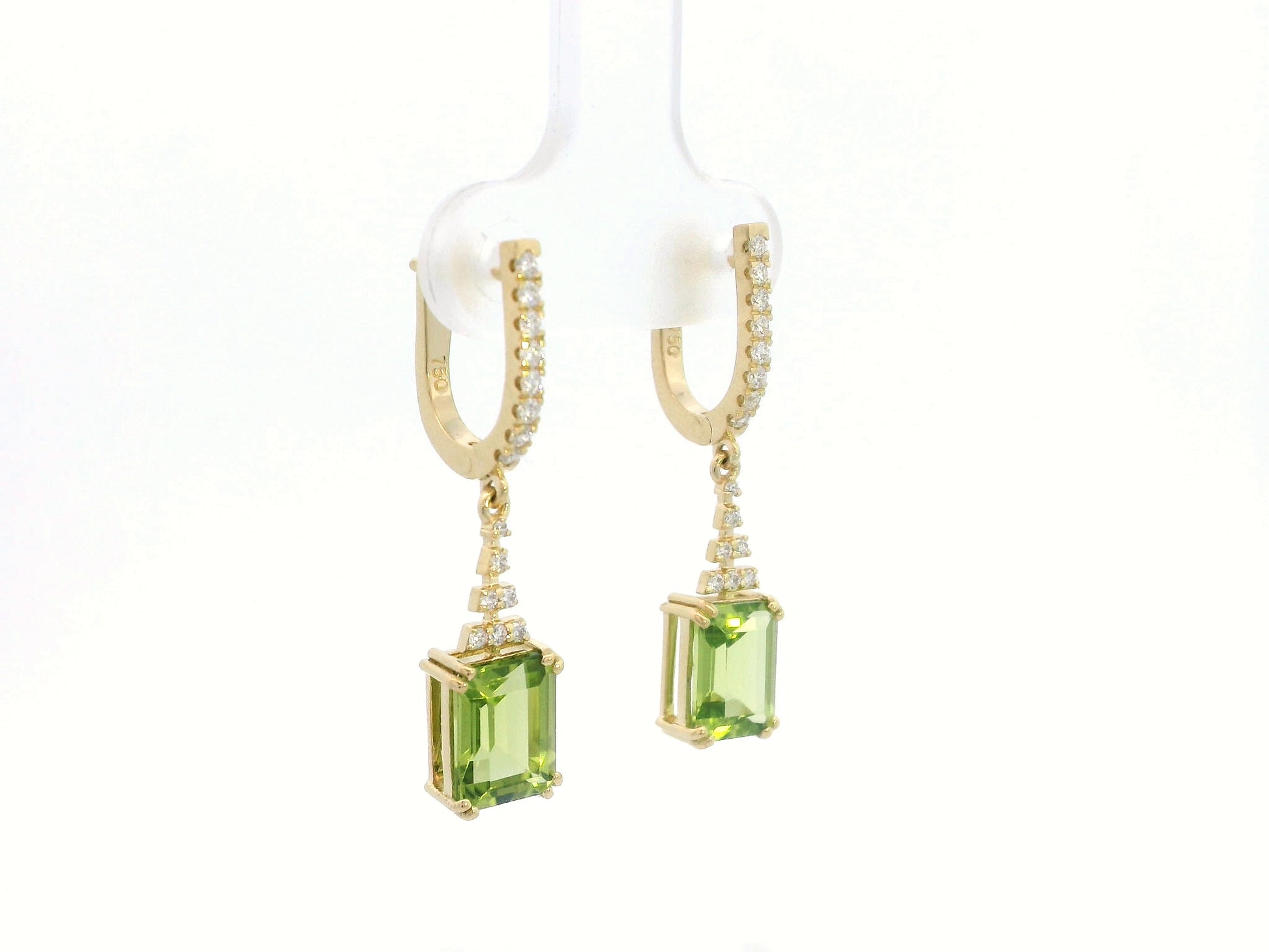 Emerald-cut Peridot and diamond drop earrings in 18K white gold, featuring vibrant green gemstones and brilliant diamond accents.