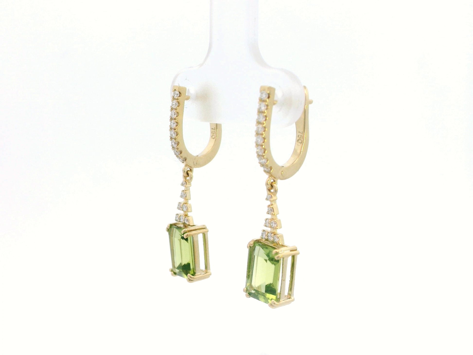 Emerald-cut Peridot and diamond drop earrings in 18K white gold, featuring vibrant green gemstones and brilliant diamond accents.