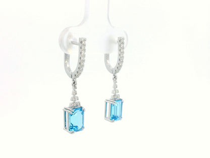 Emerald-cut Blue Topaz dangle earrings with diamond-studded huggie hoops in 18K white gold