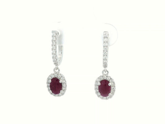 Elegant oval-cut Ruby and diamond halo drop earrings in 18K white gold, featuring 1.40 carats of deep red Rubies and 0.43 carats of sparkling diamonds.