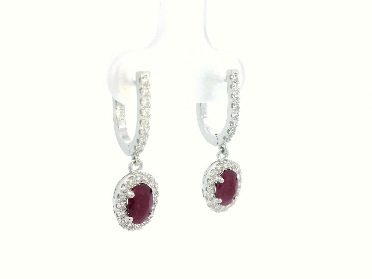 Elegant oval-cut Ruby and diamond halo drop earrings in 18K white gold, featuring 1.40 carats of deep red Rubies and 0.43 carats of sparkling diamonds.