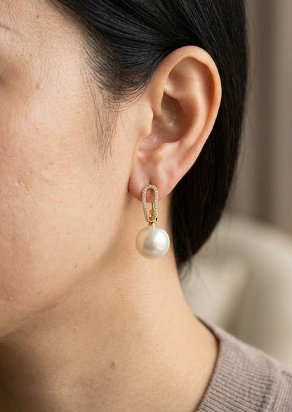 South Sea pearl drop earrings in 18K yellow gold with diamond-set elongated loops and 9 x 13 mm white pearls