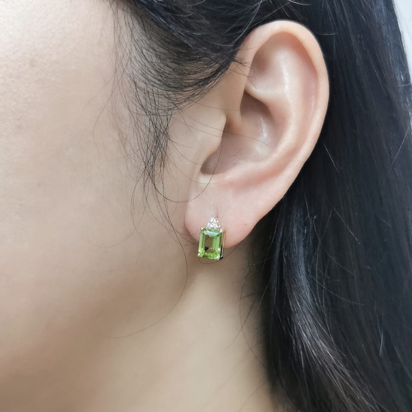 18K gold Peridot earrings with diamond accents, featuring emerald-cut 3.23 carat Peridot gemstones and 0.05 carat diamonds, 