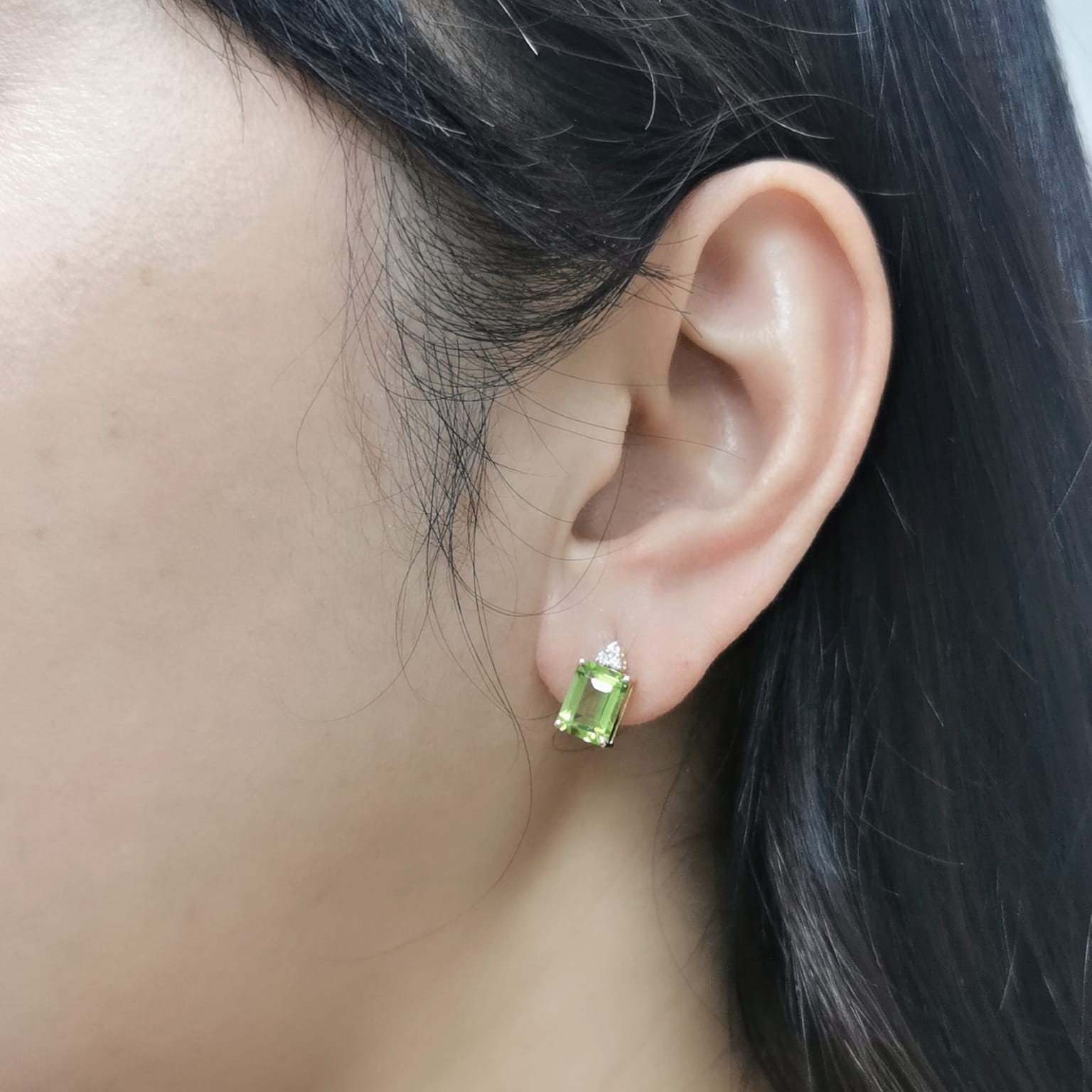 18K gold Peridot earrings with diamond accents, featuring emerald-cut 3.23 carat Peridot gemstones and 0.05 carat diamonds, 