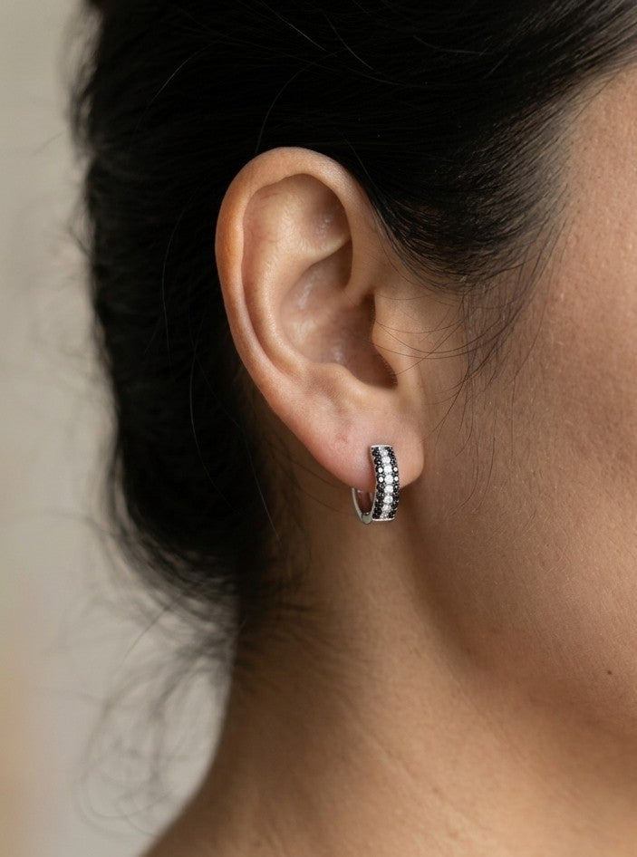 Black and white diamond hoop earrings in 18K white gold with three rows of round diamonds