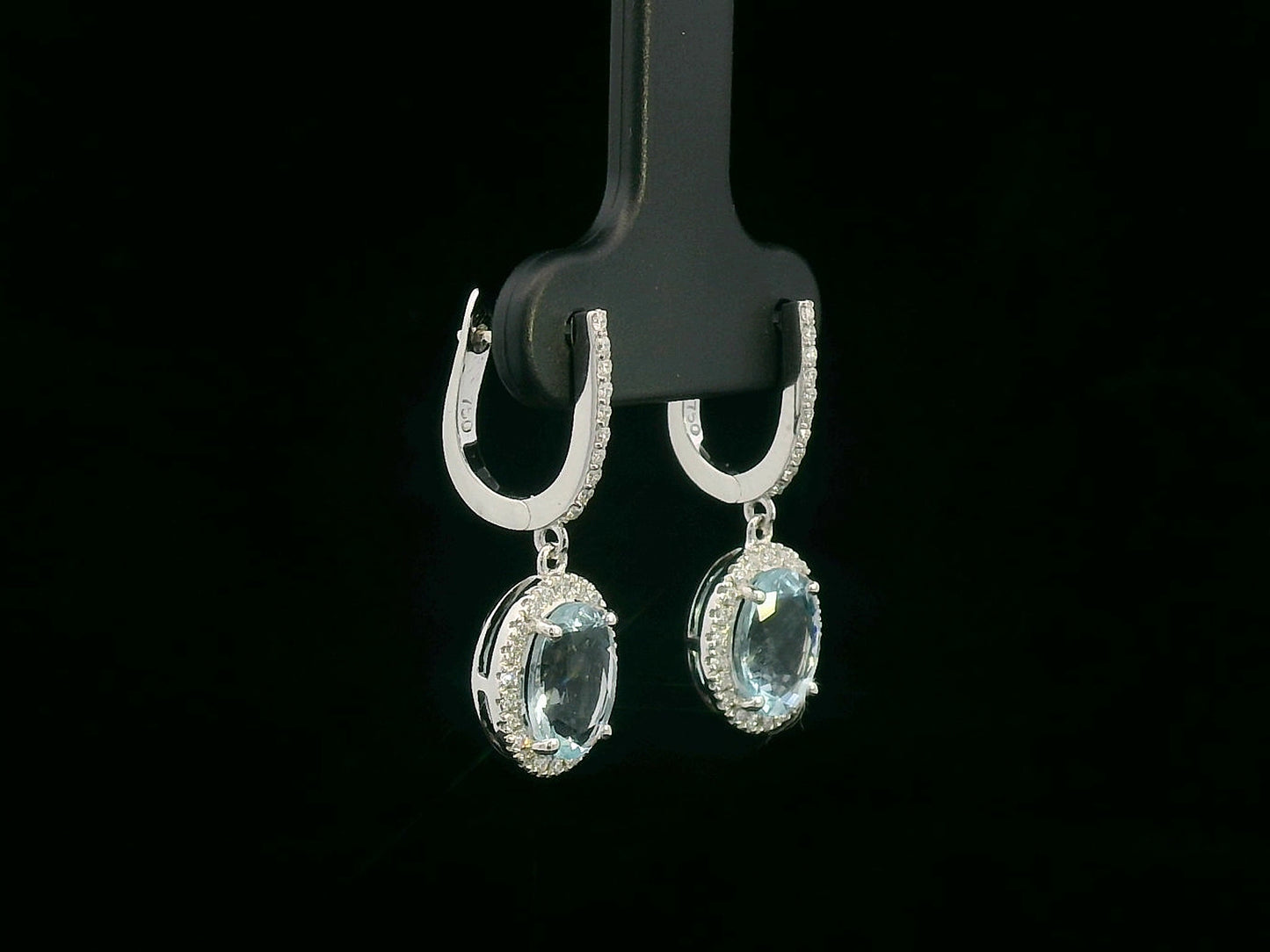 18K gold drop earrings with oval aquamarine center stones and diamond halo design

