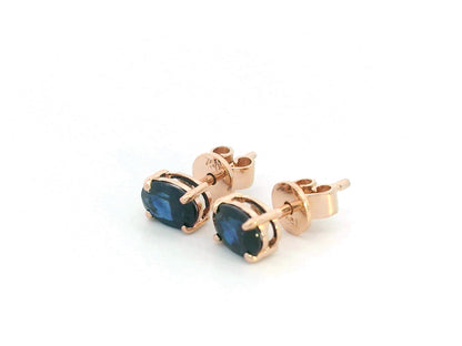 18K rose gold stud earrings with oval-cut natural blue sapphires totaling 1.06 carats, four-prong set with butterfly push backs.