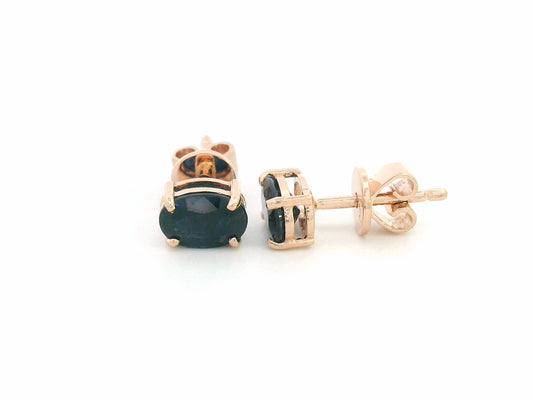 18K rose gold stud earrings with oval-cut natural blue sapphires totaling 1.06 carats, four-prong set with butterfly push backs.