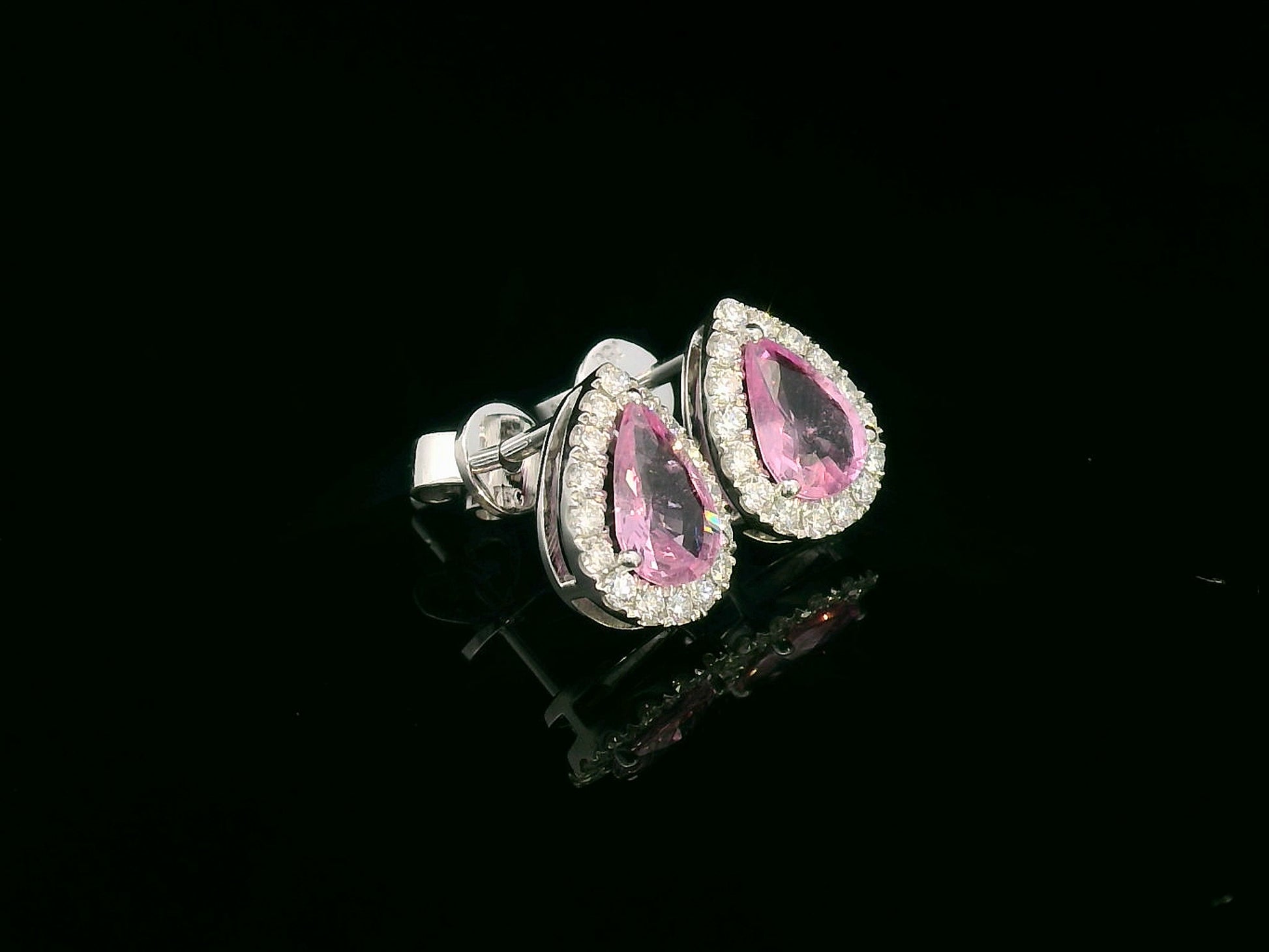 Pear-shaped pink sapphire stud earrings with diamond halo in 18K white gold – 1.38ct sapphires and 0.33ct diamonds