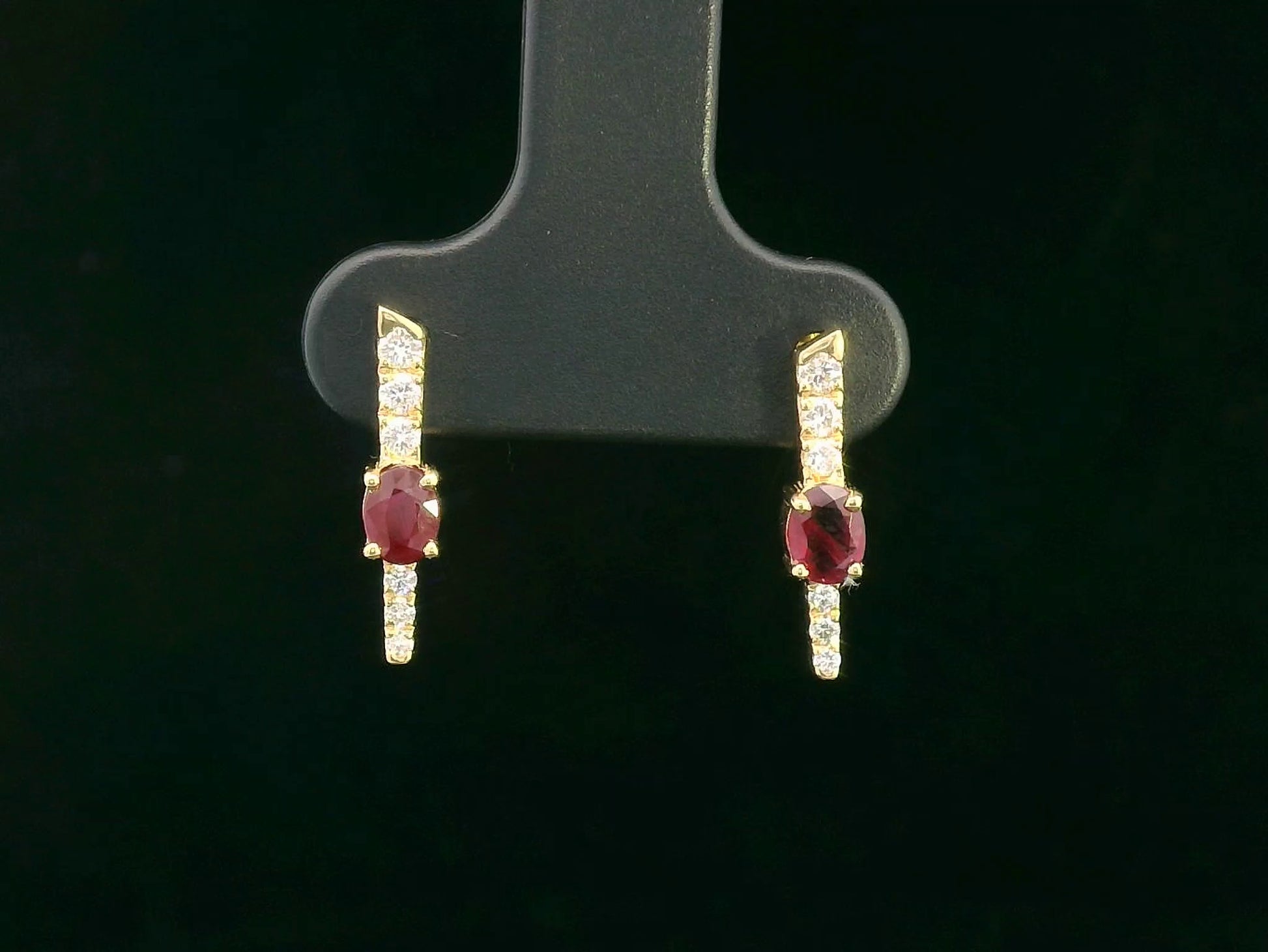 18K gold vertical earrings with 0.51ct oval rubies and 0.16ct round diamonds in a linear design with screw-back posts