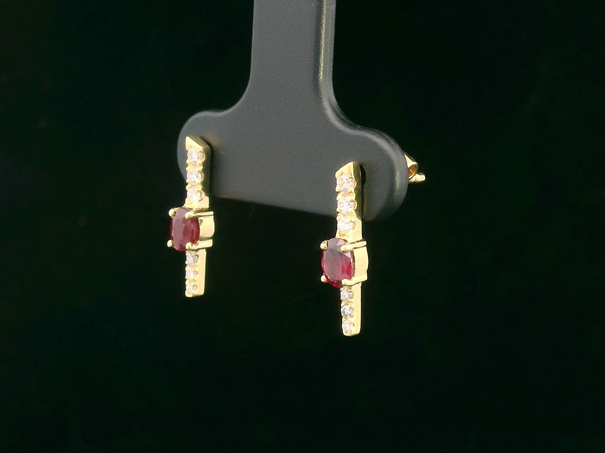 18K gold vertical earrings with 0.51ct oval rubies and 0.16ct round diamonds in a linear design with screw-back posts