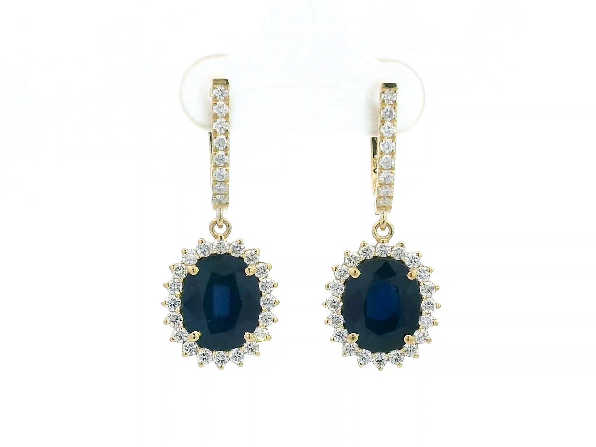 18K yellow gold earrings with 6.41ct oval blue sapphires and 0.91ct diamond sunburst halo design