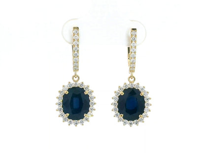 18K yellow gold earrings with 6.41ct oval blue sapphires and 0.91ct diamond sunburst halo design