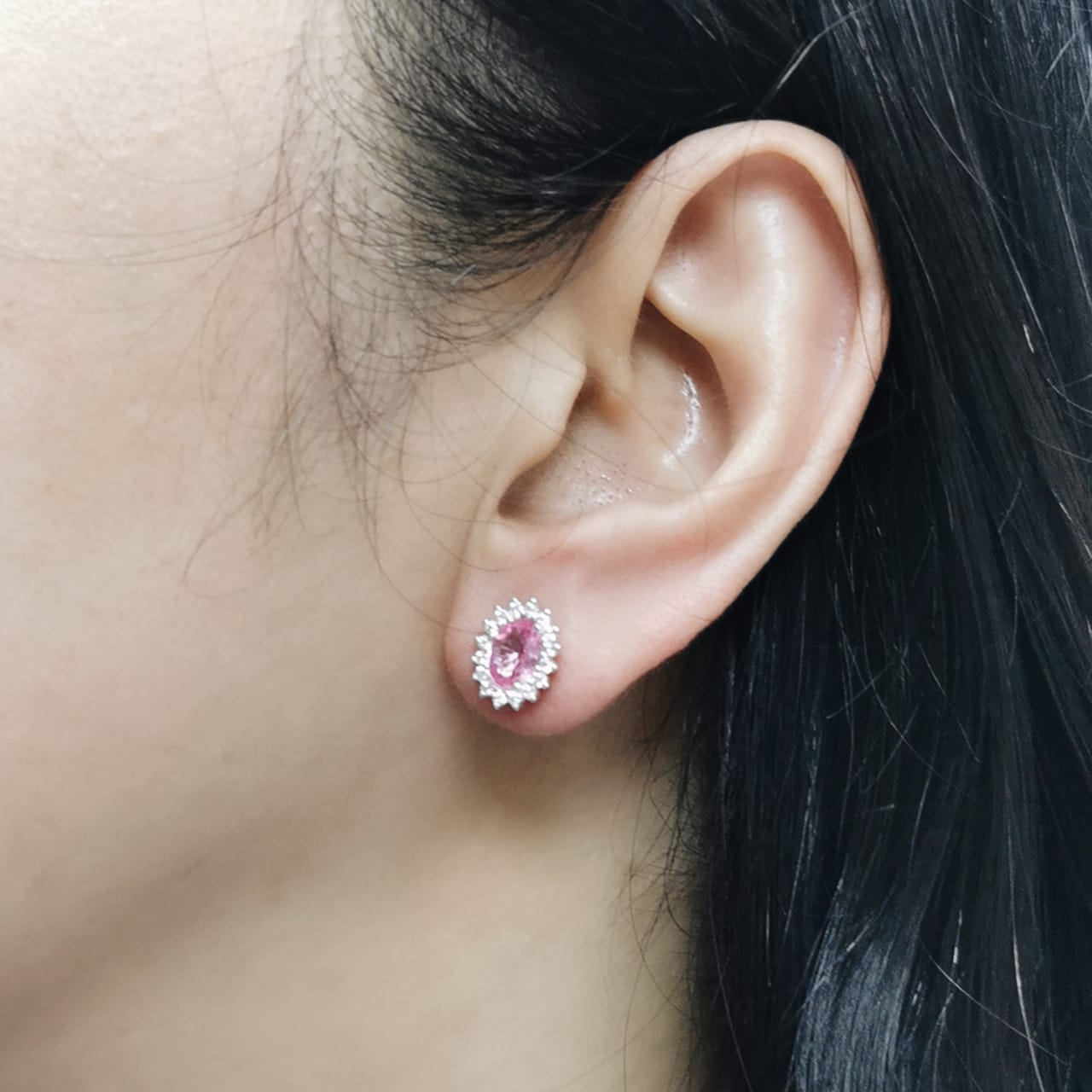 Oval pink sapphire stud earrings with diamond starburst halo in 18K gold
