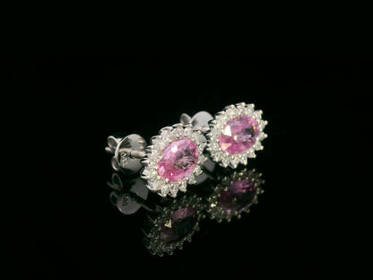 Oval pink sapphire stud earrings with diamond starburst halo in 18K gold