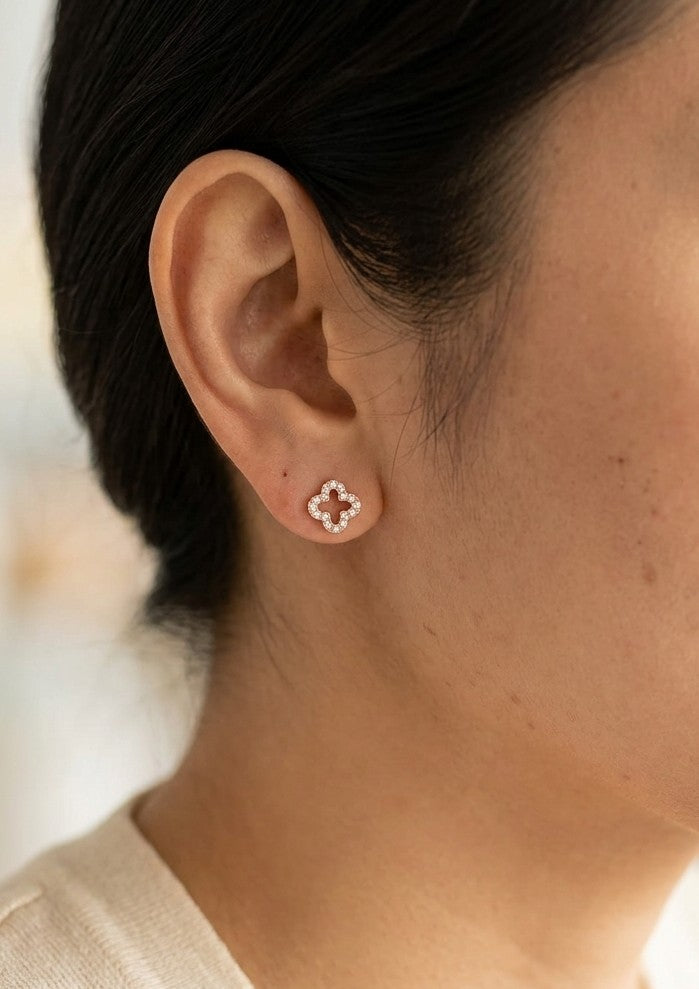 Dainty diamond clover stud earrings in 18K rose gold with round brilliant diamonds and open four-petal design