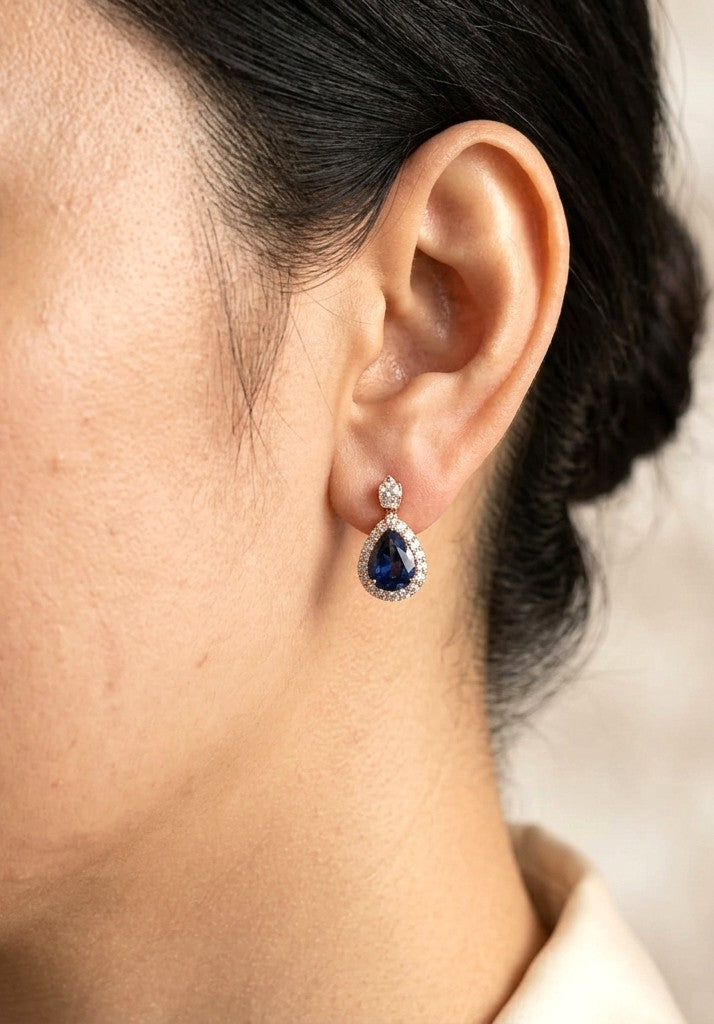 Pear shaped blue sapphire and diamond drop earrings in 18K rose gold with diamond halos