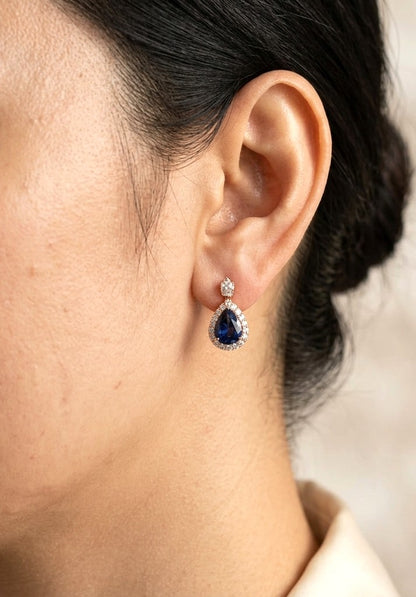 Pear shaped blue sapphire and diamond drop earrings in 18K rose gold with diamond halos