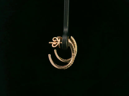 Gold earring on a black background