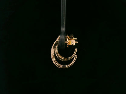 Crisscross diamond half-hoop earrings in 18K rose gold featuring 0.28 carats of pavé-set round diamonds in an overlapping X design.


