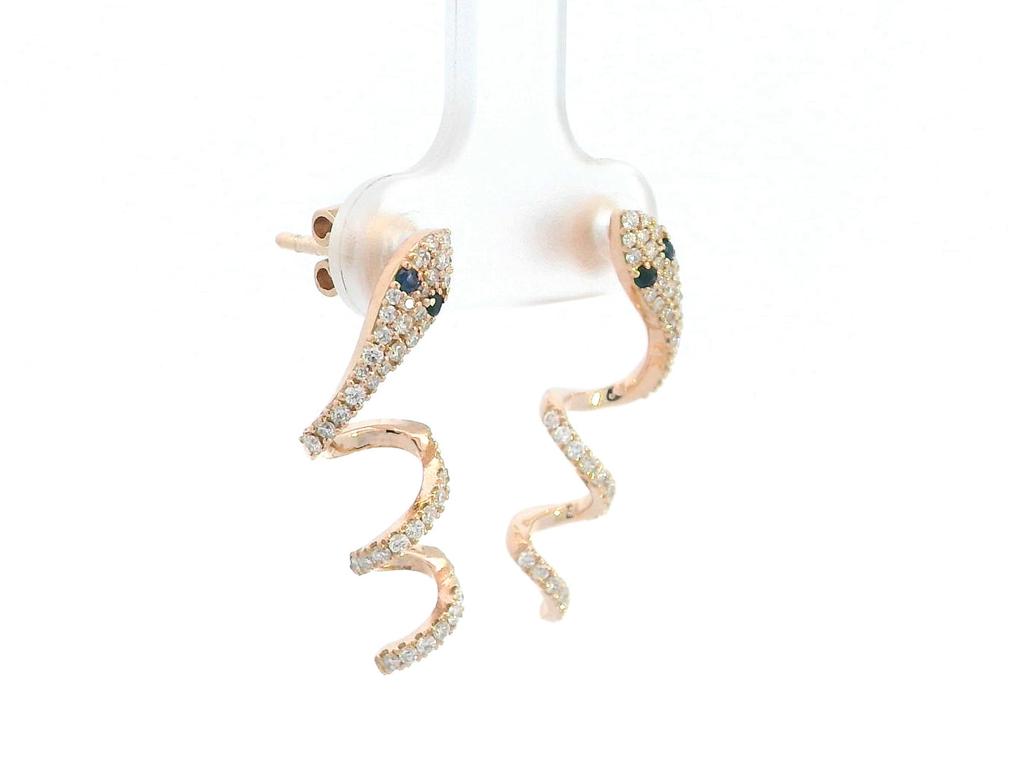 Sculptural snake-shaped earrings in rose gold with diamonds and blue sapphires