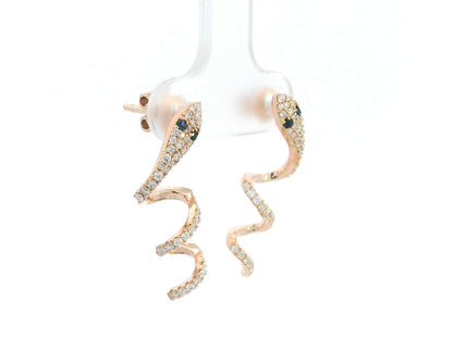 Sculptural snake-shaped earrings in rose gold with diamonds and blue sapphires