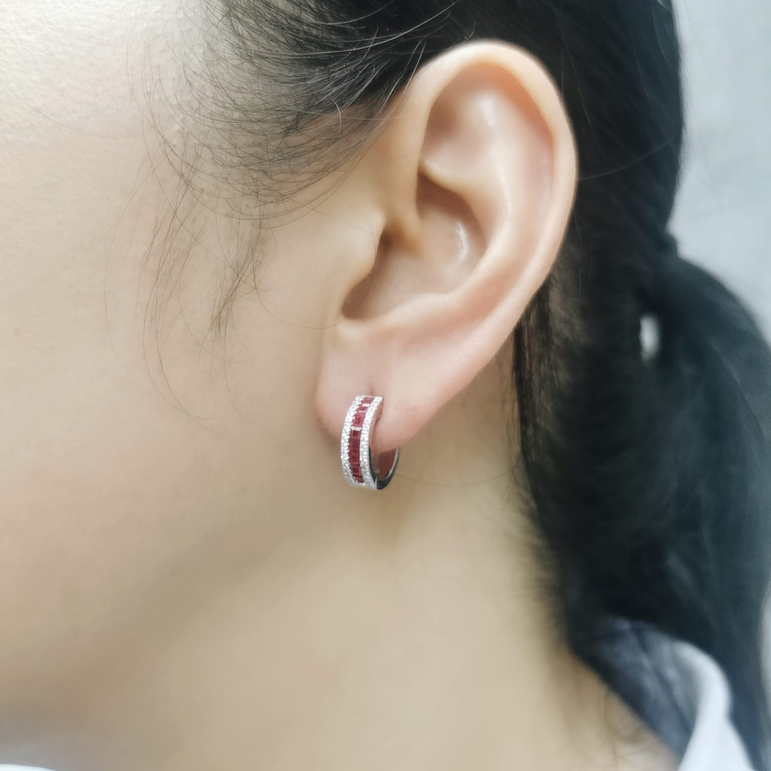 Ruby huggie earrings in white gold with diamond borders
