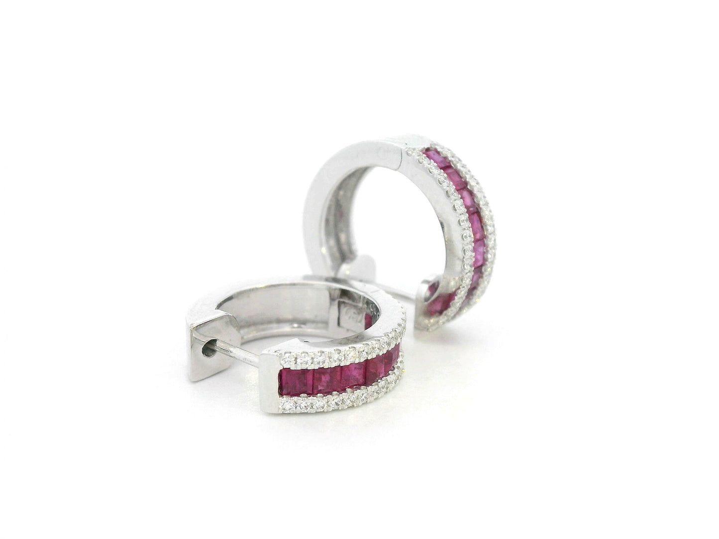 Close-up of huggie earrings featuring channel-set rubies and pavé diamonds