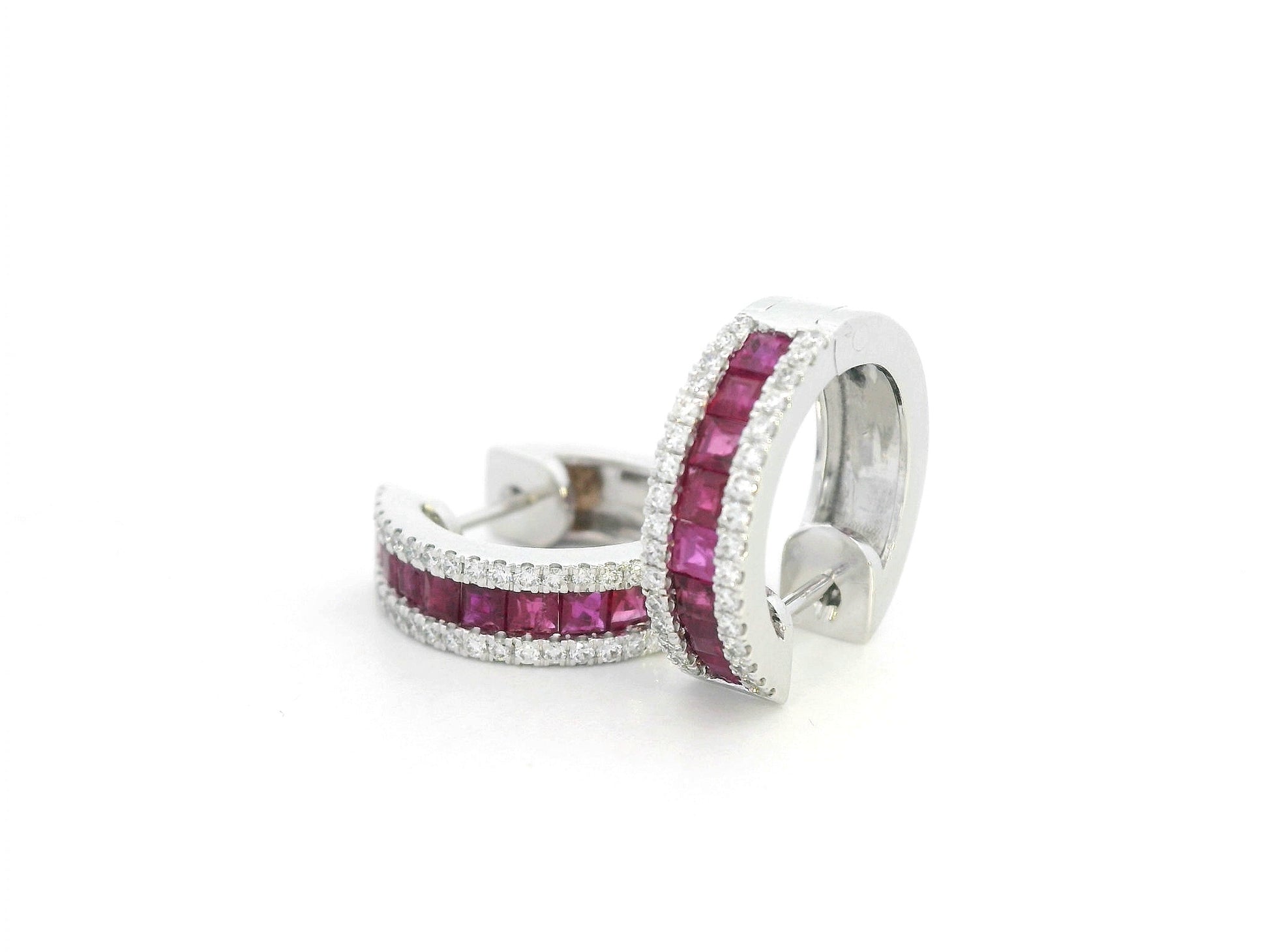 Elegant ruby and diamond hoop earrings photographed on a white background

