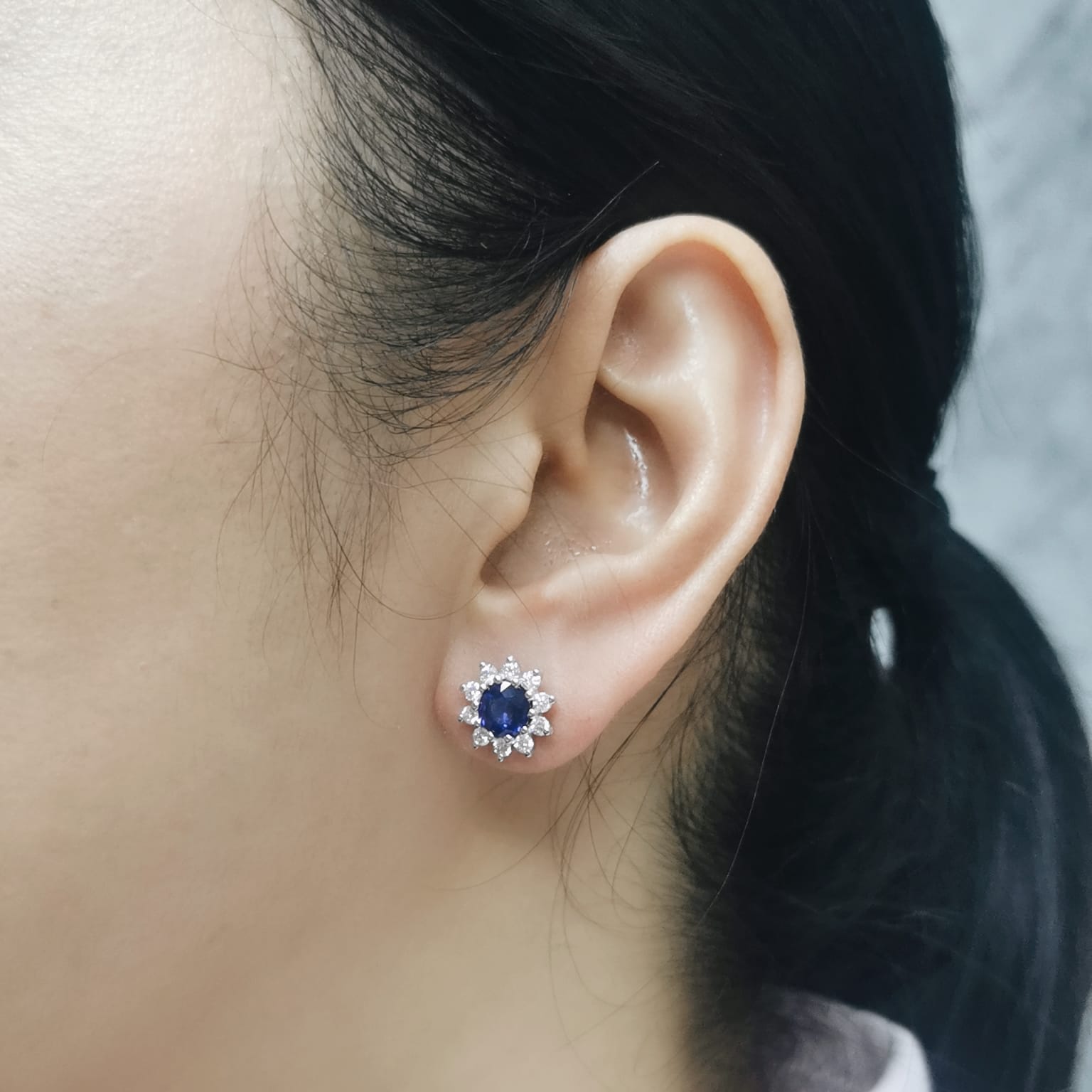 Blue sapphire halo stud earrings with sunburst diamond design