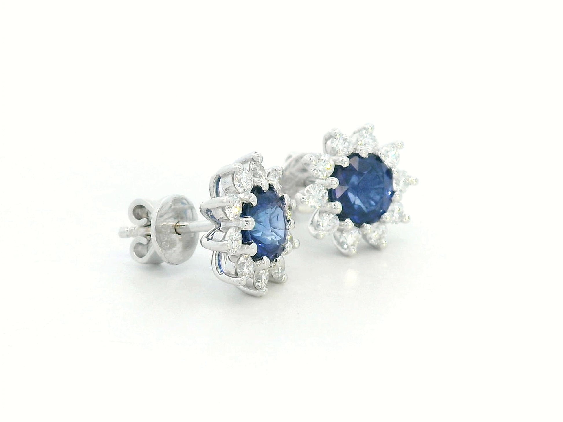 Blue sapphire halo stud earrings with sunburst diamond design
