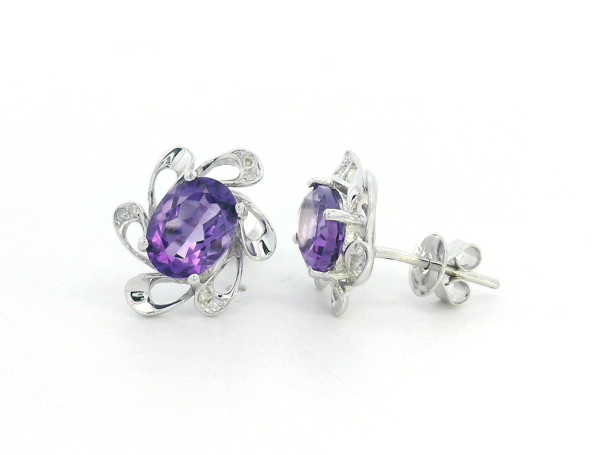 Purple amethyst earrings with diamond accents in white gold, elegant floral setting