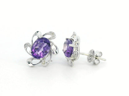 Purple amethyst earrings with diamond accents in white gold, elegant floral setting