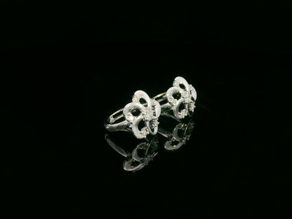 White gold earrings shaped like a flower with diamond accents