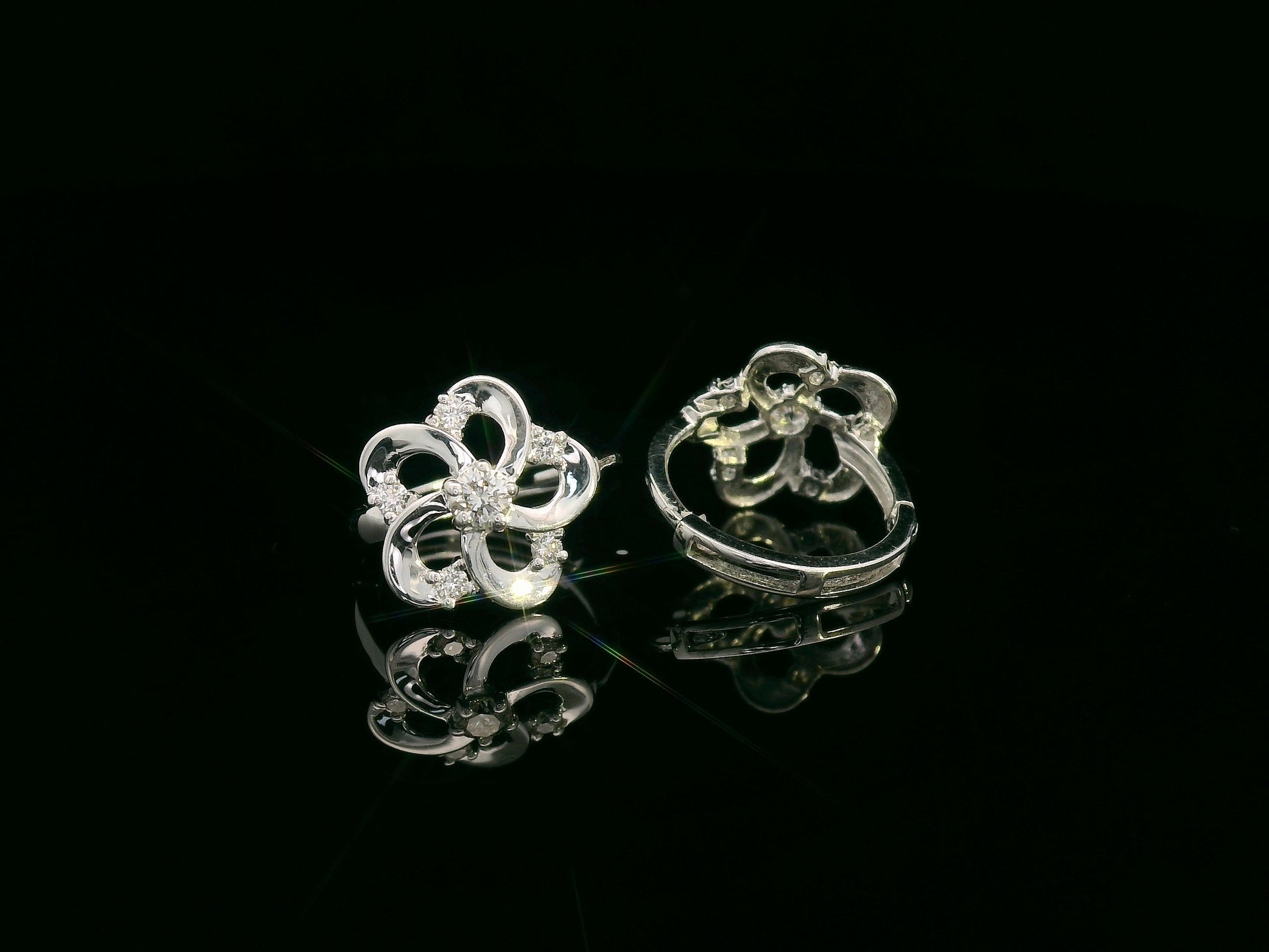White gold earrings shaped like a flower with diamond accents